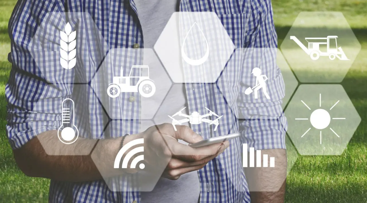 Man farmer with digital tablet in field using apps
